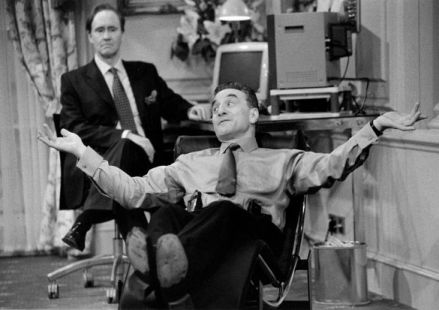 A man reclines in a chair while another man watches - Production shot for Feelgood