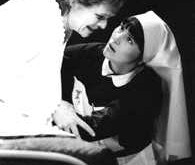 Woman on bed talking to nurse - Our Lady of Sligo production photo