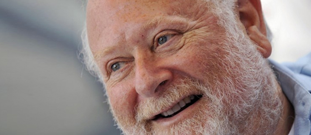 close up of a man with a white beard smiling